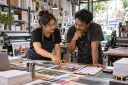 The shop owner and production lead discuss the next operating step among current print tools.