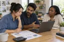A business owner and colleagues review a website budget and ongoing work plan.